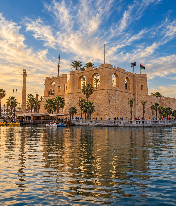 Tripoli Castle at sunset with palm trees and water reflections